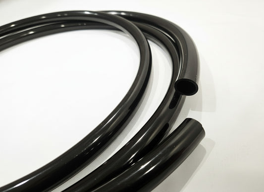 Coiled black tube on a white background